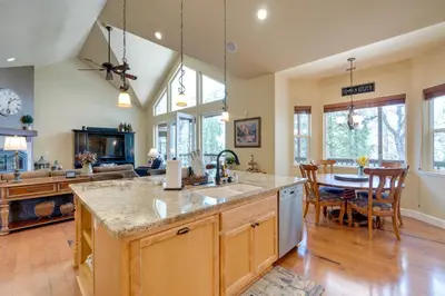 a kitchen and dining room with a table and chairs at Furnished Decks and Grill Peaceful Pioneer Home! in Pioneer