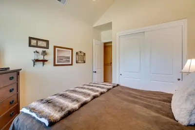 a bedroom with a bed with a blanket on it at Furnished Decks and Grill Peaceful Pioneer Home! in Pioneer