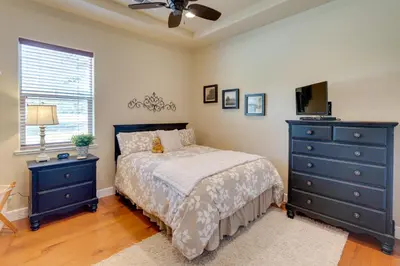 a bedroom with a bed and a dresser and a television at Furnished Decks and Grill Peaceful Pioneer Home! in Pioneer