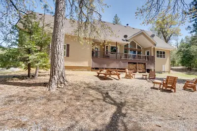 a house with a porch and a deck with benches at Furnished Decks and Grill Peaceful Pioneer Home! in Pioneer