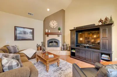 a living room with a large television and a fireplace at Furnished Decks and Grill Peaceful Pioneer Home! in Pioneer