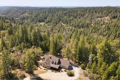 an aerial view of a house in the woods at Furnished Decks and Grill Peaceful Pioneer Home! in Pioneer
