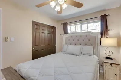 a bedroom with a white bed with a ceiling fan at Gateway to Mt Rose Ski! Reno Home Near Casinos in Reno