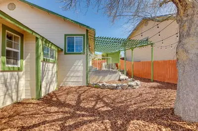 a house with a tree and a fence at Gateway to Mt Rose Ski! Reno Home Near Casinos in Reno