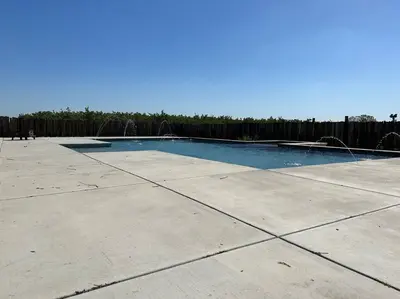 a swimming pool in a yard with a fence at Adorable One Bedroom Cottage in Oakdale