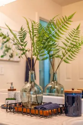 three vases sitting on a counter with plants in them at Manic Mountain Forest Cabin 3 miles from Bass Lake in Oakhurst