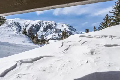 a pile of snow with a mountain in the background at Snowcreek II 2 plus loft 2 bathroom end unit condo sleeping 8 people with amazing mountain view in Mammoth Lakes