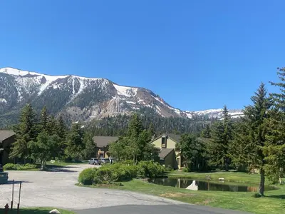 a house with a mountain in the background at Snowcreek II 2 plus loft 2 bathroom end unit condo sleeping 8 people with amazing mountain view in Mammoth Lakes