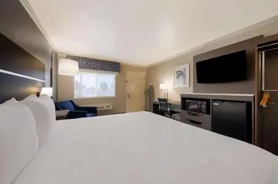 a hotel room with a large bed and a flat screen tv at Best Western Inn & Suites Lemoore in Lemoore
