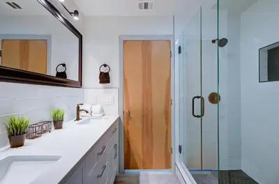 a bathroom with two sinks and a shower at The Cedar Tree in Fresno