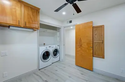 a laundry room with a washer and dryer at The Cedar Tree in Fresno