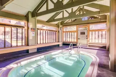 a large pool in a room with windows at Snowcreek 234 in Mammoth Lakes