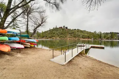 a dock with boats parked on the shore of a lake at Groveland Vacation Rental about 24 Mi to Yosemite! in Groveland