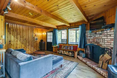 a living room with a couch and a fireplace at Groveland Vacation Rental about 24 Mi to Yosemite! in Groveland