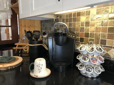 a kitchen counter top with a coffee maker and cups at Tahoe Cottage perfect for couples and outdoor enthusiasts in South Lake Tahoe