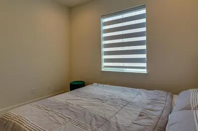 a bedroom with a bed and a window at California Midterm Rental with Fenced Yard! in Tracy