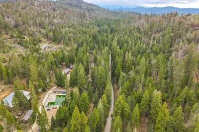 an aerial view of a house in the middle of a forest at Creekside Cabin about 20 Mi to Kings Canyon Park! in Badger