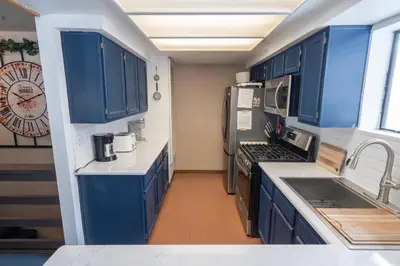 a kitchen with blue cabinets and a clock on the wall at Rr-edgewater06 in June Lake