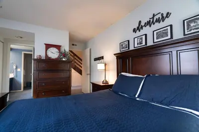 a bedroom with a large bed with a clock on the wall at Rr-edgewater06 in June Lake