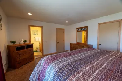 a bedroom with a bed and a dresser and a mirror at Rr-johnson Suite 2 in June Lake