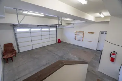an empty garage with two garage doors and a refrigerator at Rr-johnson Suite 2 in June Lake