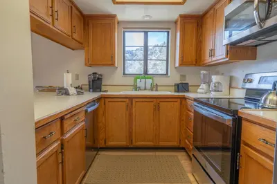 a kitchen with wooden cabinets and a window at Rr-interlaken 25 in June Lake