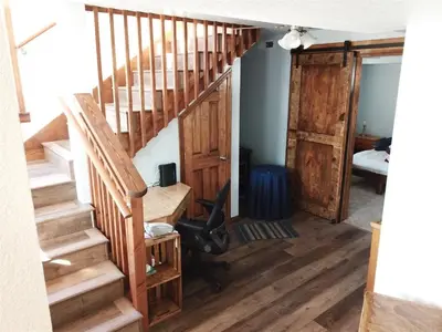 a room with a wooden staircase with a desk and a door at Rr-gull Lake Baby House in June Lake