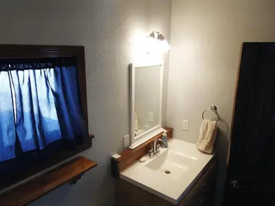 a bathroom with a sink and a mirror at Rr-gull Lake Baby House in June Lake