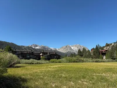 a field with houses and mountains in the background at Rr-edgewater09 in June Lake
