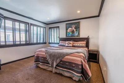 a bedroom with a bed in a room with windows at Rr-edgewater20 in June Lake