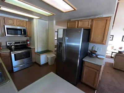 a kitchen with a stainless steel refrigerator and wooden cabinets at Rr-edgewater13 in June Lake