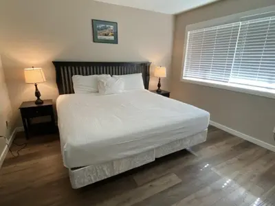 a bedroom with a large white bed with two lamps at Rr-edgewater17 in June Lake