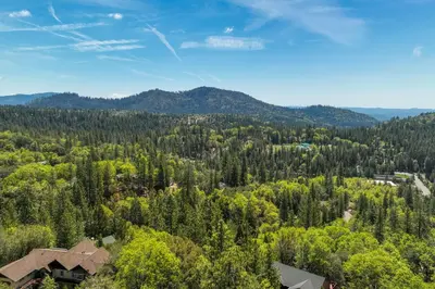 an aerial view of a forest with houses and mountains at Hike, Bike and Golf Peaceful Cabin in Twain Harte! in Twain Harte