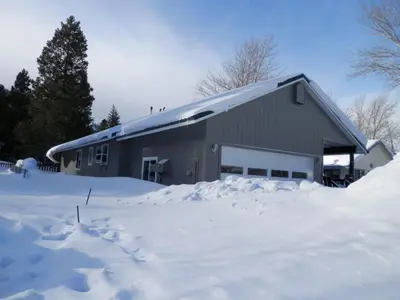 a barn covered in snow with a pile of snow at Elk House in June Lake