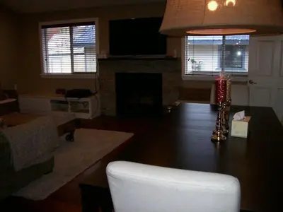 a living room with a table with a lamp and a fireplace at Elk House in June Lake