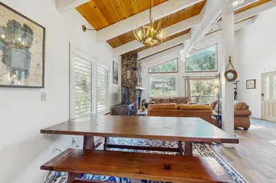 a living room with a table and a couch at Saddle Road Sanctuary in South Lake Tahoe
