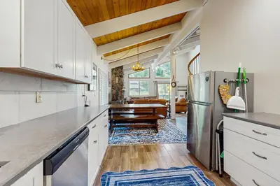 a kitchen with white cabinets and a stainless steel refrigerator at Saddle Road Sanctuary in South Lake Tahoe