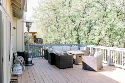 a deck with chairs and a table on a porch at Casita- Lake Area Winter Special Ends 51626 in Bass Lake
