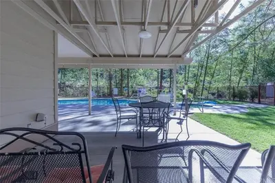 a patio with a table and chairs and a pool at Rosenberg Slide Creek Reduced Nightly Rate in Bass Lake