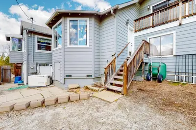 a house with a staircase in front of it at Wilts Happy Place in Bass Lake