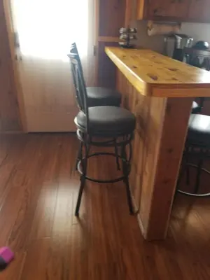a bar with two stools at a kitchen counter at 3BR Panoramic Lake View, Sequoia Forest, Kern County in Wofford Heights