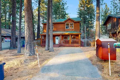 a log cabin in the woods with a driveway at Charming Mt Rose Retreat in South Lake Tahoe