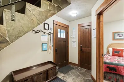 a room with a staircase and a bed in a room at Northstar Ski in Ski out 2BR Condo in Truckee
