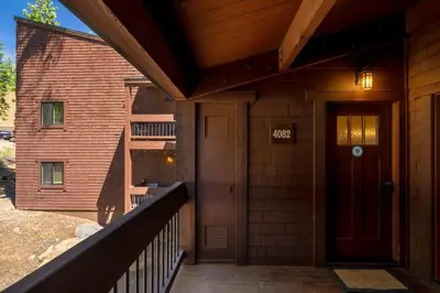 a porch of a building with a door and a staircase at Northstar Ski in Ski out 2BR Condo in Truckee