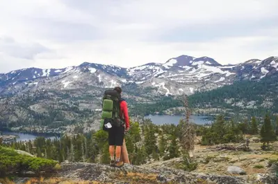 a person standing on top of a mountain looking at the mountains at Northstar Ski in Ski out 2BR Condo in Truckee