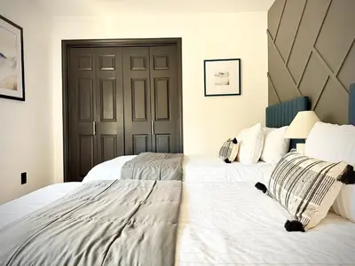 a bedroom with two beds and a large door at Prime location Yosemite Expedition by Casa Oso in Oakhurst