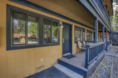 a porch of a house with a bench on it at Lakeside Studio Steps from the Beach in Tahoe Vista