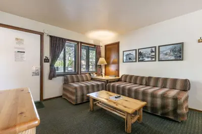 a living room with two couches and a table at Lakeside Studio Steps from the Beach in Tahoe Vista