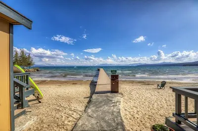a beach with a trash can and the ocean at Lakeside Studio Steps from the Beach in Tahoe Vista