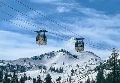 two gondolas on a ski lift over a snow covered mountain at Lakeside Studio Steps from the Beach in Tahoe Vista